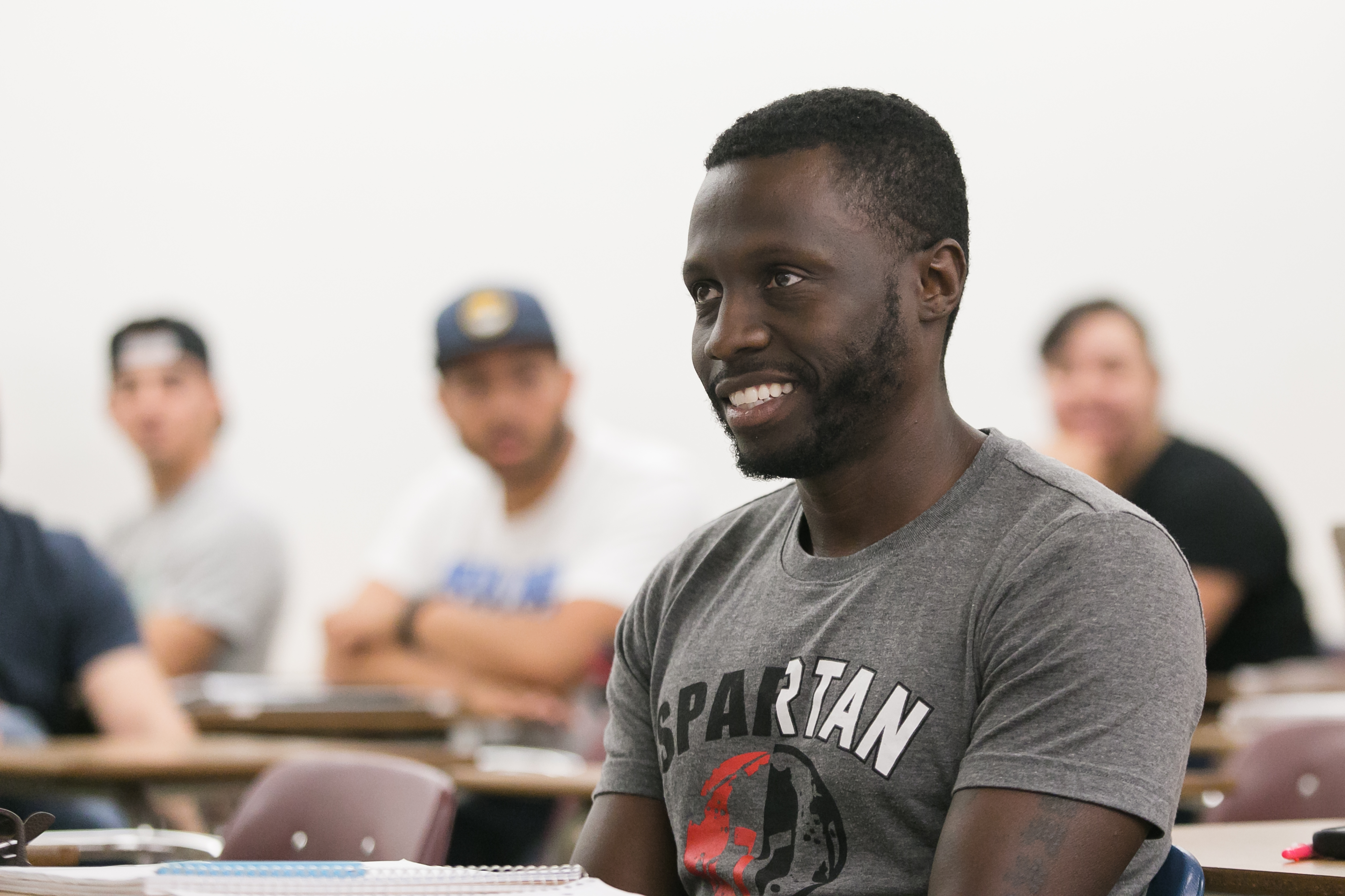 A smiling African American male in a classroom